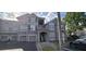 Apartment building with gray facade, covered parking, and well-maintained landscaping at 3379 S Kirkman Rd # 1015, Orlando, FL 32811
