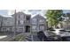 Apartment building with gray facade, covered parking, and well-maintained landscaping at 3379 S Kirkman Rd # 1015, Orlando, FL 32811