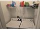 Laundry room with white washing machine and dryer and wire shelving above at 3379 S Kirkman Rd # 1015, Orlando, FL 32811