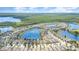 Aerial view of the community showcasing the neighborhood, lakes, and surrounding trees in a scenic area at 3443 Sagebrush St, Harmony, FL 34773