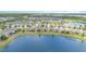 Beautiful aerial view of a lakeside residential community with well-maintained homes and lush greenery at 3443 Sagebrush St, Harmony, FL 34773