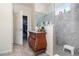 Modern bathroom featuring a glass-enclosed shower with gray tiles and a dark wood vanity cabinet at 3443 Sagebrush St, Harmony, FL 34773