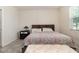 Well-lit bedroom featuring tile floors, a patterned comforter, and a decorative bench adding comfort and style at 3443 Sagebrush St, Harmony, FL 34773