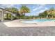 Community pool area showcasing a large pool, plenty of lounge chairs, and a covered patio area, perfect for relaxation at 3443 Sagebrush St, Harmony, FL 34773
