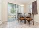 Cozy dining area with a glass table, four chairs, and sliding doors to the backyard at 3443 Sagebrush St, Harmony, FL 34773