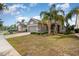View of well-maintained single-Gathering homes with manicured lawns and mature palm trees at 3443 Sagebrush St, Harmony, FL 34773