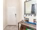 Bright foyer featuring a mirrored table, decor and door to the rest of the home at 3443 Sagebrush St, Harmony, FL 34773