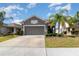 Charming single Gathering home featuring a two-car garage and landscaped front yard at 3443 Sagebrush St, Harmony, FL 34773