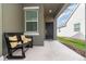 Inviting front porch with a cozy bench and decorative pillows near the main entry at 3443 Sagebrush St, Harmony, FL 34773