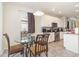 Bright kitchen features stainless steel appliances, white cabinetry, and a charming breakfast nook with glass-top table at 3443 Sagebrush St, Harmony, FL 34773