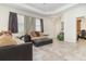 Bright and airy living room with large windows and an open doorway to another room at 3443 Sagebrush St, Harmony, FL 34773