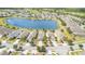Street view featuring beautiful homes, well-maintained landscaping, and a tranquil lake in the distance, creating an inviting atmosphere at 3443 Sagebrush St, Harmony, FL 34773