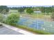 Well-maintained tennis and pickleball courts surrounded by mature trees, offering recreational opportunities for residents at 3443 Sagebrush St, Harmony, FL 34773