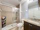 Tiled bathroom features a glass enclosed shower and vanity with stone countertop at 3450 Puxton Dr, Orlando, FL 32824