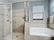 Bright bathroom featuring a walk-in shower, soaking tub, and tile surround at 3450 Puxton Dr, Orlando, FL 32824