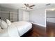 Bright bedroom boasts ample closet space, a ceiling fan, and hardwood floors at 3450 Puxton Dr, Orlando, FL 32824