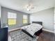 Bedroom with hardwood floors, two windows, and a contemporary style rug at 3450 Puxton Dr, Orlando, FL 32824