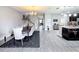 Open-concept living and dining areas flow into a kitchen with an island and modern fixtures at 3450 Puxton Dr, Orlando, FL 32824