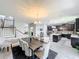 Modern dining and kitchen space with a table, island with seating, and wood-look floors at 3450 Puxton Dr, Orlando, FL 32824