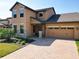 Charming two-story home with a brick driveway, landscaped yard, and an attached two-car garage at 3450 Puxton Dr, Orlando, FL 32824