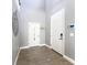 Bright foyer with gray walls, wood-look tile flooring, and high ceilings, creating an open and airy feel at 3450 Puxton Dr, Orlando, FL 32824