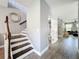 Home hallway featuring stairs, plank flooring, and gray-painted walls at 3450 Puxton Dr, Orlando, FL 32824