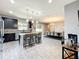 Open kitchen with dark cabinetry, large island, modern lighting, stainless steel appliances, and dining area at 3450 Puxton Dr, Orlando, FL 32824