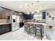 Well-appointed kitchen features dark cabinets, granite countertops, stainless steel appliances and backsplash at 3450 Puxton Dr, Orlando, FL 32824