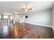 Spacious living room with hardwood floors and a ceiling fan provides a comfortable gathering space at 3450 Puxton Dr, Orlando, FL 32824