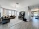 Spacious living room featuring a neutral color palette, stylish decor, wood-look tile flooring, and natural light at 3450 Puxton Dr, Orlando, FL 32824