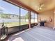 Enjoy this screened patio with a ceiling fan, grilling station, and view of the backyard at 3450 Puxton Dr, Orlando, FL 32824
