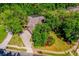 Enjoy an aerial view of this home with solar panels surrounded by lush greenery at 3831 River Hollow Ct, Oviedo, FL 32765