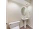 Small half bathroom with pedestal sink, mirror, and toilet at 3831 River Hollow Ct, Oviedo, FL 32765