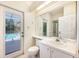 Bathroom with a pool view, single sink, and a toilet at 3831 River Hollow Ct, Oviedo, FL 32765