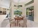 Sunlit breakfast nook with views of the pool area, perfect for casual dining and entertaining at 3831 River Hollow Ct, Oviedo, FL 32765
