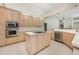 Well-lit kitchen featuring an island cooktop, stainless steel appliances, and ample cabinetry at 3831 River Hollow Ct, Oviedo, FL 32765