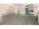 Spacious living room with carpet, large window, and slider to a pool area at 3831 River Hollow Ct, Oviedo, FL 32765