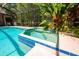 View of the large pool and in-ground spa, surrounded by lush landscaping at 3831 River Hollow Ct, Oviedo, FL 32765