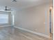 Bright living room with wood-look floors, fan and neutral walls with a view to the outside at 3960 Southpointe Dr # 501, Orlando, FL 32822