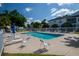 Relax by the community pool with ample lounge chairs and umbrellas on a sunny day at 3960 Southpointe Dr # 501, Orlando, FL 32822