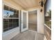 A sun-filled porch with tile floor leads through a glass-paneled door to a bright, neutral room at 3960 Southpointe Dr # 501, Orlando, FL 32822