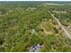 Aerial view highlighting a partially cleared parcel of land, surrounded by trees at 4000 Rouse Rd, Orlando, FL 32817