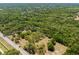 Aerial view showcases a generous wooded parcel of land, perfect for secluded development at 4000 Rouse Rd, Orlando, FL 32817