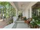 Inviting back porch with comfortable seating overlooking the lush backyard landscape at 4000 Rouse Rd, Orlando, FL 32817