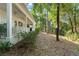 Side view of home featuring a back porch and mature trees and landscaping providing privacy at 4000 Rouse Rd, Orlando, FL 32817