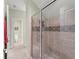 Bright bathroom features a glass-enclosed shower with decorative tile and tiled floors at 4000 Rouse Rd, Orlando, FL 32817