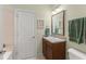Bathroom with vanity, sink, framed mirror, and tiled walk-in shower at 4000 Rouse Rd, Orlando, FL 32817