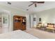 Spacious bedroom with a decorative ceiling fan, wooden storage unit, and comfortable seating area at 4000 Rouse Rd, Orlando, FL 32817