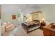 Bedroom with neutral colored walls, a canopy bed, a chair, and carpet at 4000 Rouse Rd, Orlando, FL 32817