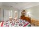 Bedroom features a comfortable quilt, dresser, and an ensuite bathroom and closet at 4000 Rouse Rd, Orlando, FL 32817